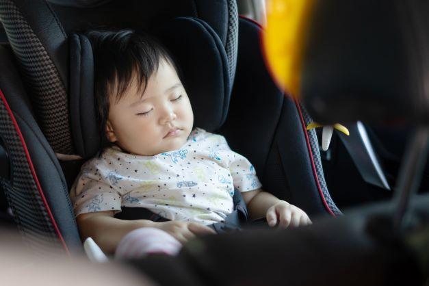 child sleeping in car